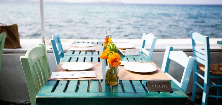 A reserved table in a restaurant with an ocean view